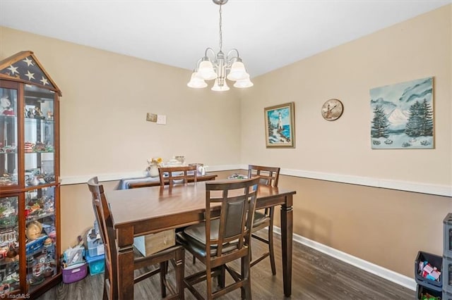 dining space featuring an inviting chandelier and dark wood-type flooring