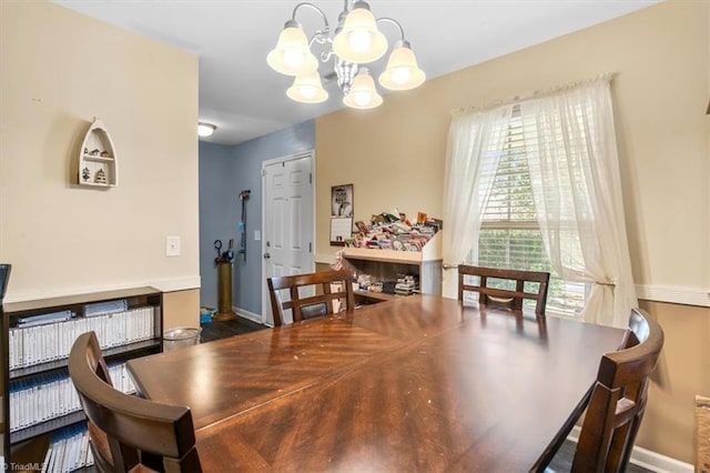 dining space with dark hardwood / wood-style flooring and a notable chandelier