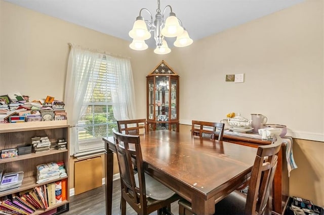 dining area featuring hardwood / wood-style flooring and a notable chandelier