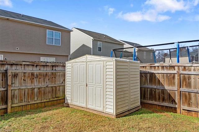 view of outdoor structure featuring a yard and a trampoline