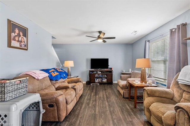 living room with ceiling fan and dark wood-type flooring