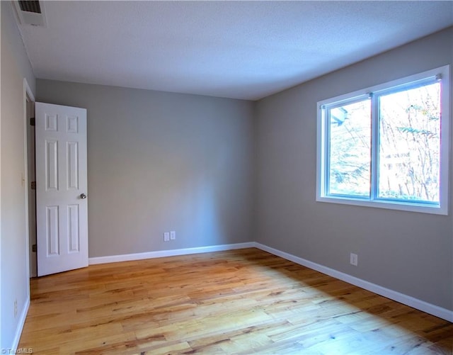 unfurnished room featuring light hardwood / wood-style floors