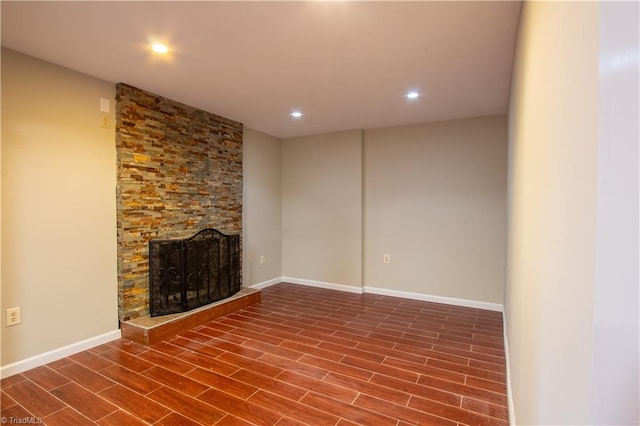 unfurnished living room featuring a fireplace and hardwood / wood-style floors