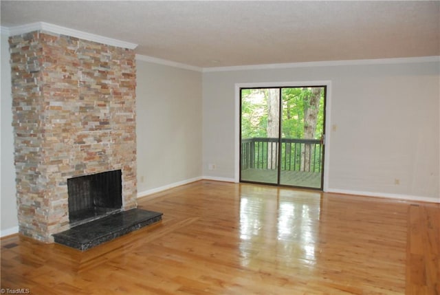 unfurnished living room with a stone fireplace, ornamental molding, and light hardwood / wood-style floors