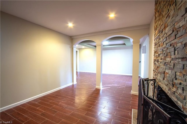 spare room with dark wood-type flooring and ornate columns