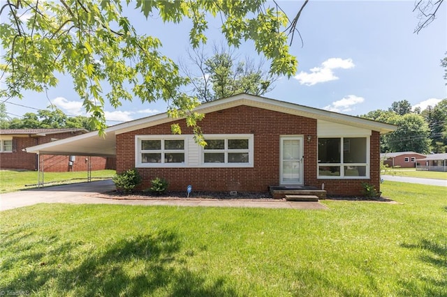 ranch-style home featuring a front yard and a carport