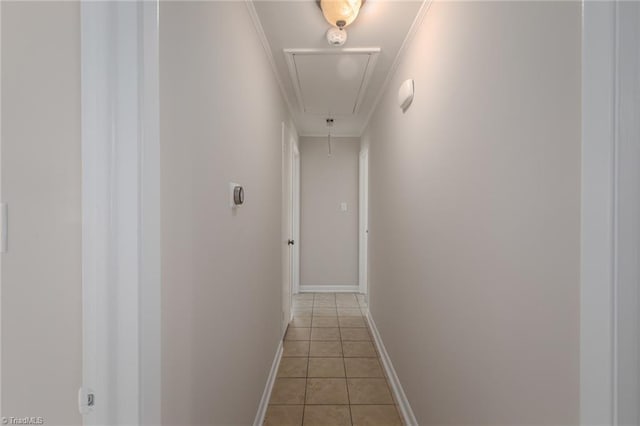 corridor featuring light tile patterned floors and ornamental molding