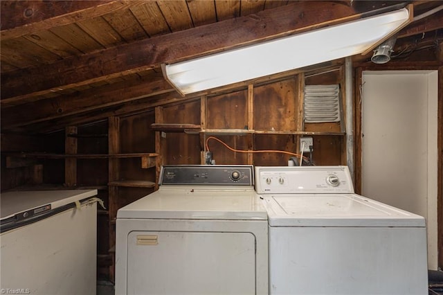 laundry area with washing machine and dryer and wooden ceiling