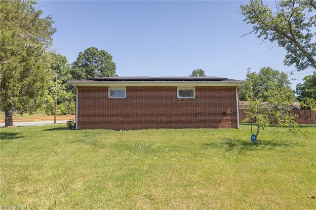 view of side of home with a lawn