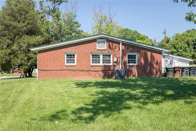 rear view of property featuring a lawn