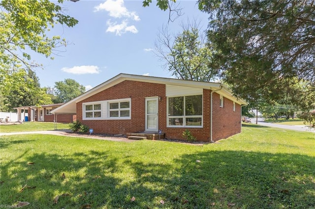 ranch-style house with a front lawn and a carport