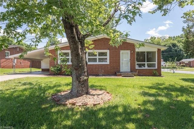 single story home featuring a carport and a front lawn