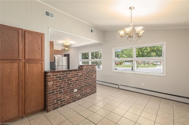 kitchen featuring pendant lighting, crown molding, baseboard heating, a notable chandelier, and stainless steel refrigerator