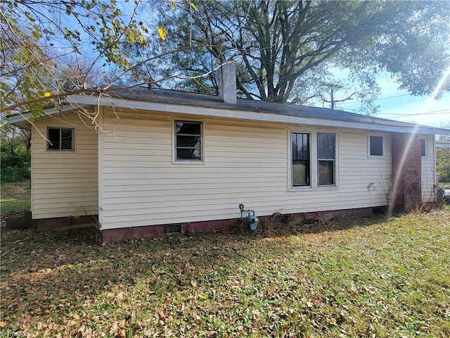 back of house with a lawn