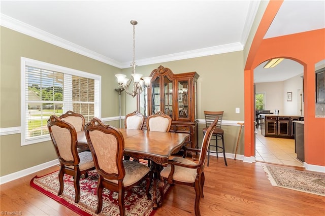 4060 Tarmac Dr, Sophia, NC 27350 - dining area with arched walkways, a chandelier, crown molding, and light wood-type flooring