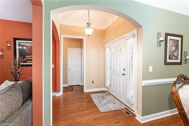 4060 Tarmac Dr, Sophia, NC 27350 - entrance foyer with arched walkways, wood finished floors, and crown molding
