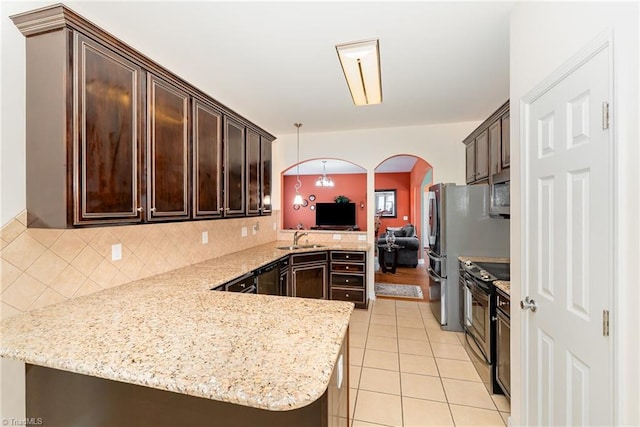 4060 Tarmac Dr, Sophia, NC 27350 - kitchen with stainless steel appliances, a peninsula, arched walkways, and dark brown cabinetry