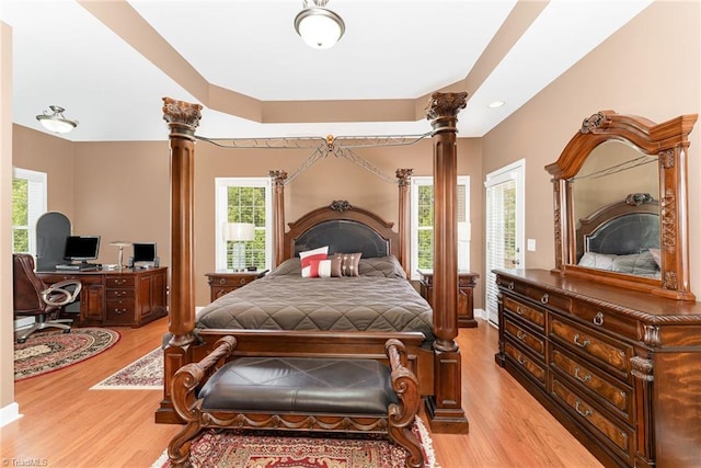 4060 Tarmac Dr, Sophia, NC 27350 - bedroom featuring decorative columns, light wood finished floors, and multiple windows