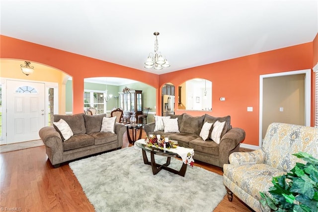 4060 Tarmac Dr, Sophia, NC 27350 - living room with a chandelier, arched walkways, and light wood-style floors
