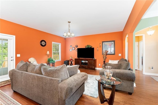 4060 Tarmac Dr, Sophia, NC 27350 - living area featuring a chandelier, wood finished floors, and arched walkways
