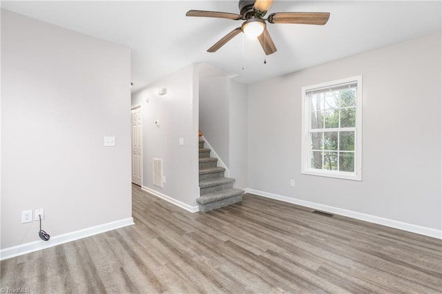 unfurnished room with light wood-type flooring and ceiling fan