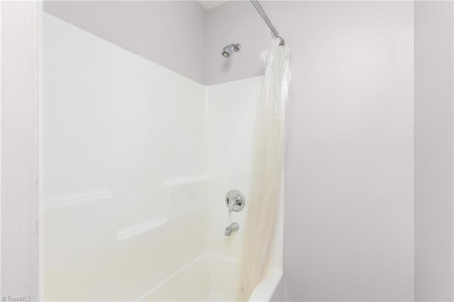 bathroom with shower / bathtub combination with curtain