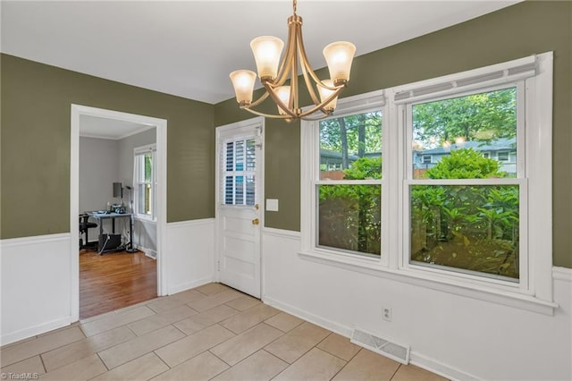 2703 W Cornwallis Dr, Greensboro, NC 27408 - unfurnished dining area featuring light tile patterned floors, a notable chandelier, wainscoting, and visible vents