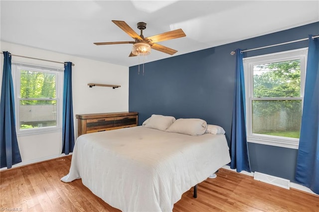 2703 W Cornwallis Dr, Greensboro, NC 27408 - bedroom with a ceiling fan, visible vents, and wood finished floors