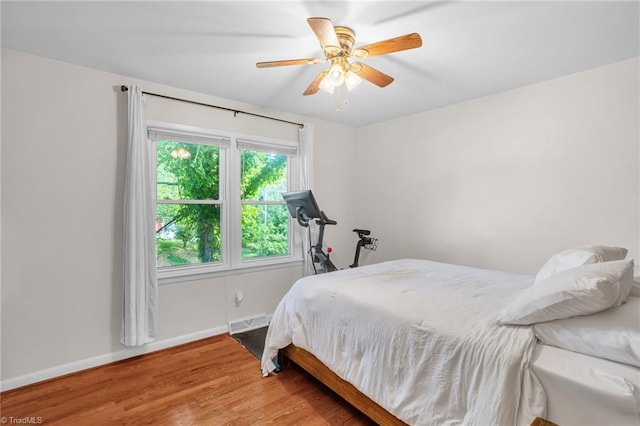2703 W Cornwallis Dr, Greensboro, NC 27408 - bedroom with baseboards, ceiling fan, visible vents, and wood finished floors