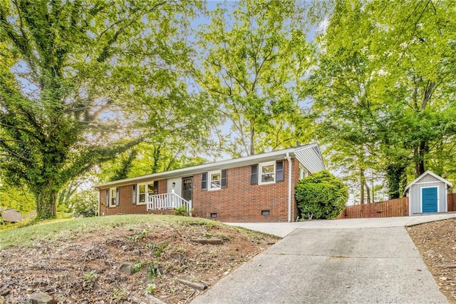 2703 W Cornwallis Dr, Greensboro, NC 27408 - single story home with an outbuilding, crawl space, fence, brick siding, and driveway