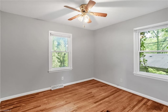 2703 W Cornwallis Dr, Greensboro, NC 27408 - unfurnished room with baseboards, ceiling fan, light wood-style floors, and visible vents