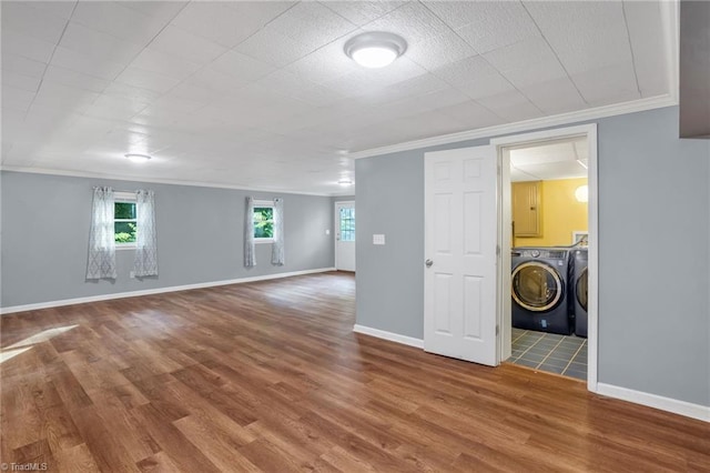2703 W Cornwallis Dr, Greensboro, NC 27408 - interior space featuring crown molding, wood finished floors, baseboards, and washing machine and clothes dryer