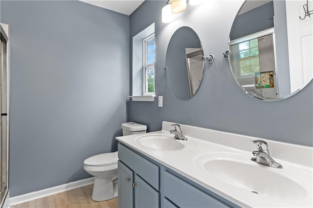 2525 Halle Ann Cir, Winston-Salem, NC 27103 - full bath with wood finished floors, toilet, a shower with shower door, baseboards, and double vanity