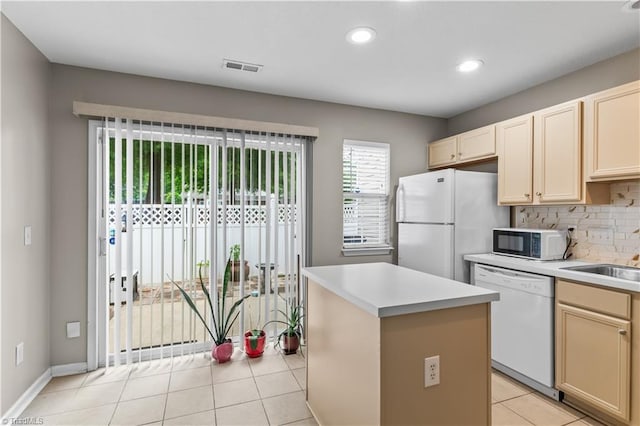 2525 Halle Ann Cir, Winston-Salem, NC 27103 - kitchen featuring white appliances, decorative backsplash, a sink, light countertops, and light tile patterned floors