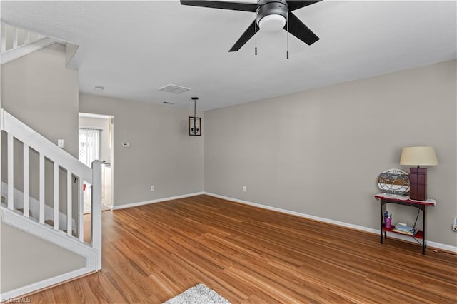 2525 Halle Ann Cir, Winston-Salem, NC 27103 - empty room featuring stairway, wood finished floors, baseboards, and a ceiling fan