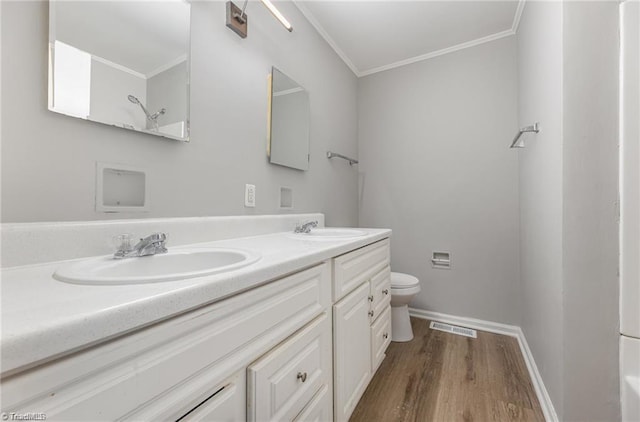 2725 New Walkertown Rd, Winston-Salem, NC 27105 - bathroom with double vanity, toilet, ornamental molding, wood finished floors, and baseboards