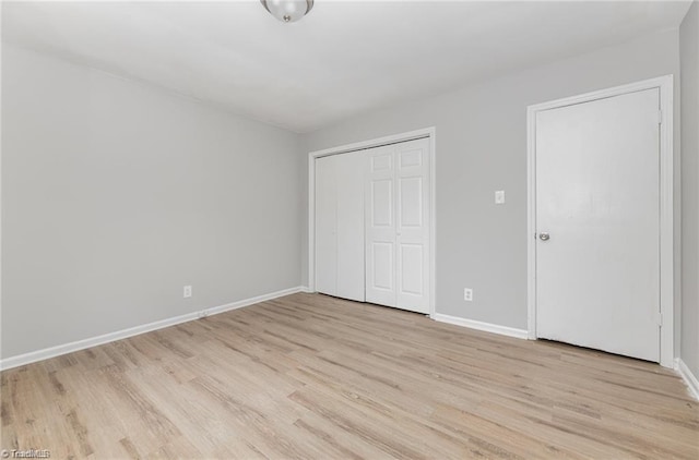 2725 New Walkertown Rd, Winston-Salem, NC 27105 - unfurnished bedroom featuring light wood-type flooring, baseboards, and a closet