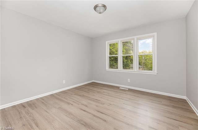 spare room featuring light hardwood / wood-style floors