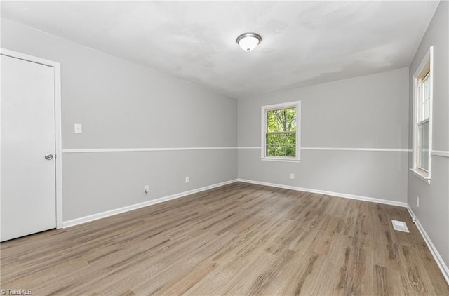 unfurnished room featuring light hardwood / wood-style floors