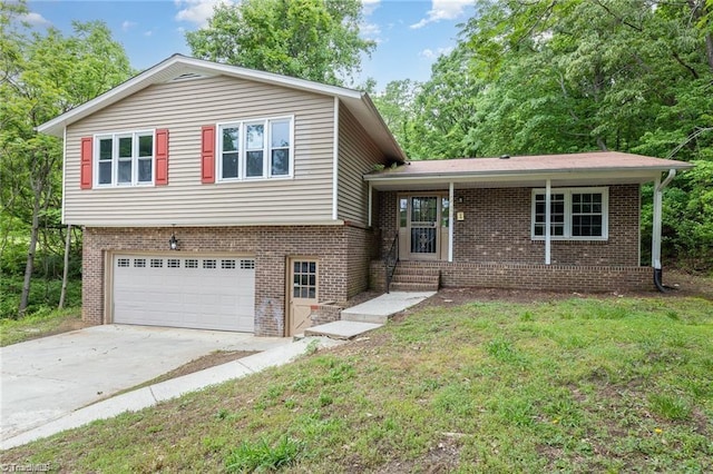 2725 New Walkertown Rd, Winston-Salem, NC 27105 - split level home with brick siding, an attached garage, and concrete driveway