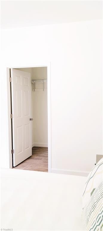 unfurnished bedroom with light wood-type flooring and a closet