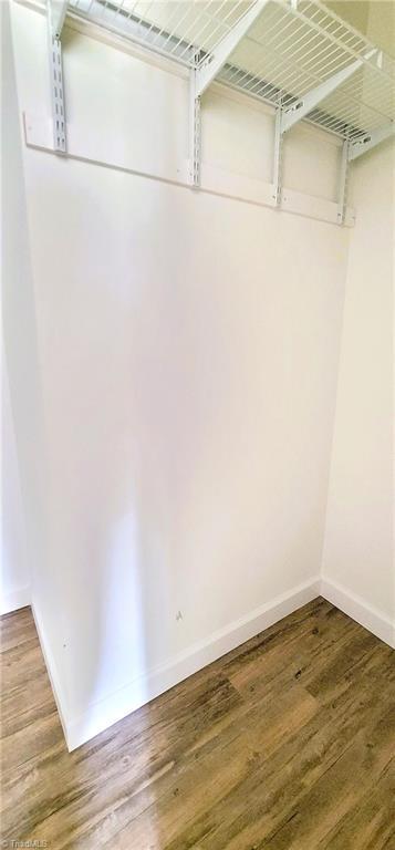 spacious closet with wood finished floors