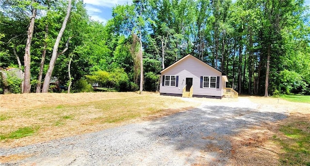 view of property exterior with crawl space and driveway