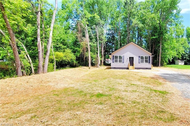view of front of home with crawl space and a front yard