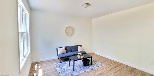 living area featuring wood finished floors and baseboards