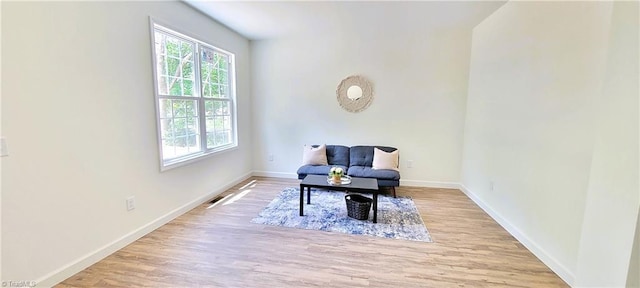 living area with wood finished floors and baseboards