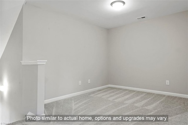 carpeted empty room featuring baseboards and visible vents