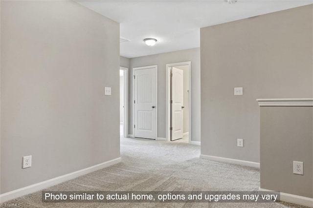 spare room with carpet floors and baseboards