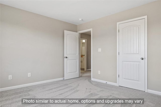 unfurnished bedroom with carpet floors and baseboards