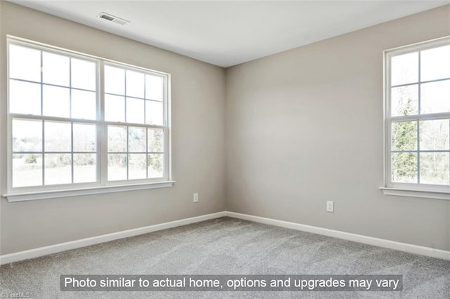 carpeted empty room with baseboards and visible vents